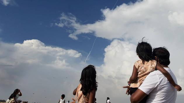 People react as they watch ISRO's Polar Satellite Launch Vehicle (PSLV-C49) carrying all weather Earth Imaging Satellite EOS-01 and nine other foreign satellites of US, Luxembourg and Lithuania, leaves a trail of smoke, at Marina beach, Chennai, Saturday.(PTI)