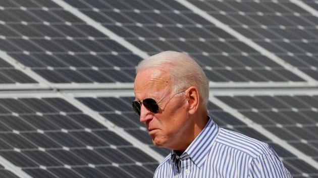 FILE PHOTO: Joe Biden walks past solar panels while touring the Plymouth Area Renewable Energy Initiative in Plymouth, New Hampshire, U.S., June 4, 2019. REUTERS/Brian Snyder/File Photo (REUTERS) FILE PHOTO: Joe Biden walks past solar panels while touring the Plymouth Area Renewable Energy Initiative in Plymouth, New Hampshire, U.S., June 4, 2019. REUTERS/Brian Snyder/File Photo (REUTERS)