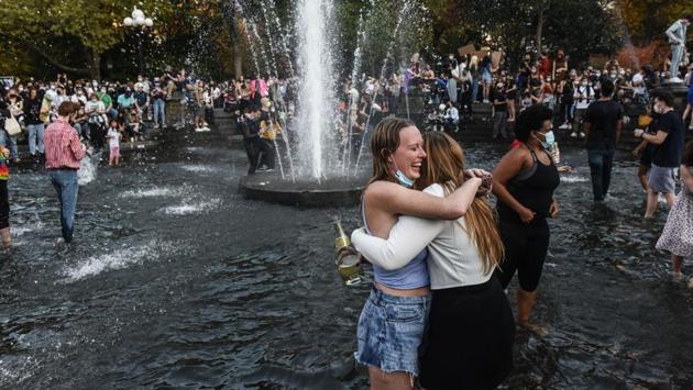 A planned demonstration in Manhattan’s Columbus Circle turned into a dance party celebrating the election’s result, while revelers at Washington Square Park in New York’s Greenwich Village danced and splashed in the park’s fountain. (Stephanie Keith / Getty Images / AFP) A planned demonstration in Manhattan’s Columbus Circle turned into a dance party celebrating the election’s result, while revelers at Washington Square Park in New York’s Greenwich Village danced and splashed in the park’s fountain. (Stephanie Keith / Getty Images / AFP)