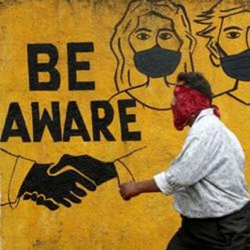 A man walks past a graffiti amid the spread of the coronavirus disease in Mumbai on November 2, 2020.(REUTERS)