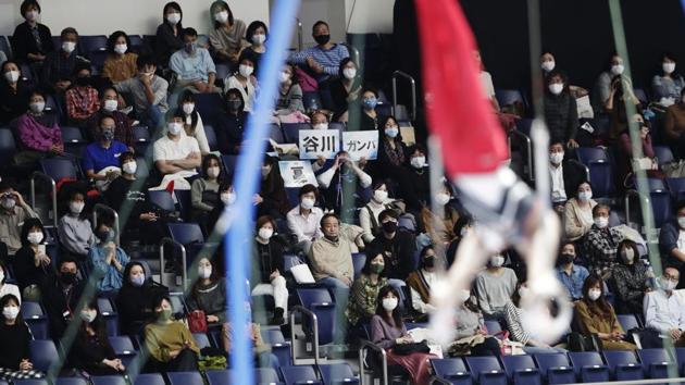 Audience members cheer for Wataru Tanigawa of Japan as he competes in the rings during an international gymnastics meet in Tokyo on Sunday, Nov. 8, 2020. Gymnasts from four countries of China, Russia, U.S. and Japan performed in the meet at Yoyogi National Stadium First Gymnasium, a venue planned to be used in the Tokyo 2020 Olympics in the summer 2021. (AP Photo/Hiro Komae)(AP)