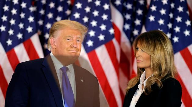 US President Donald Trump accompanied by first lady Melania Trump reacts to early results from the 2020 US presidential election in the East Room of the White House in Washington, US.(Reuters)