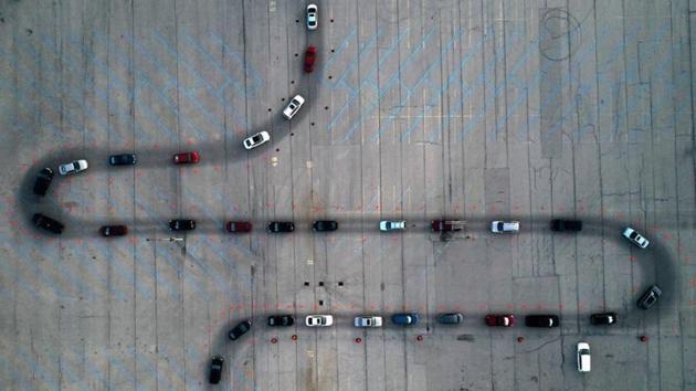 An aerial view of vehicles waiting at a drive-through Covid-19 testing site in a parking lot in Milwaukee, Wisconsin on November 5. The United States, with about 20% of global cases, is facing its worst surge, recording more than 100,000 daily coronavirus cases on the latest seven-day average, Reuters data showed. It reported a record of more than 130,000 cases on November 7. (Bing Guan / REUTERS)