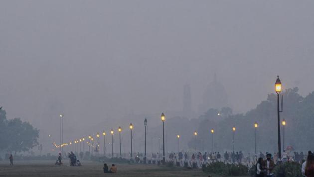 People at India Gate lawns, amid hazy weather conditions, in New Delhi on November 8. (PTI) People at India Gate lawns, amid hazy weather conditions, in New Delhi on November 8. (PTI)