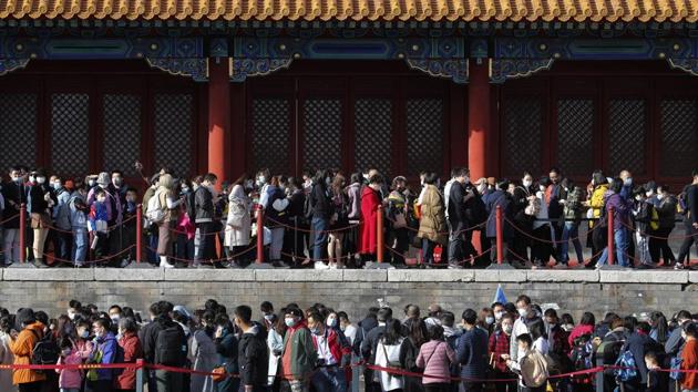 Visitors line up to enter an exhibition held at the Forbidden City in Beijing, China on November 7. The pandemic’s recent acceleration has been ferocious. It took 32 days for the number of cases to rise from 30 million to 40 million. It took just 21 days to add another 10 million. The latest seven-day average shows global daily infections are rising by more than 540,000. (Andy Wong / AP)