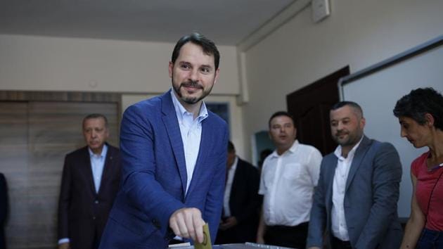 FILE - In this Sunday, June 23, 2019 file photo, Turkey's Minister of Treasury and Finance Berat Albayrak, followed by his father-in-law and Turkey's President Recep Tayyip Erdogan, left, casts his ballot at a polling station in Istanbul (AP Photo/Emrah Gurel, File) FILE - In this Sunday, June 23, 2019 file photo, Turkey's Minister of Treasury and Finance Berat Albayrak, followed by his father-in-law and Turkey's President Recep Tayyip Erdogan, left, casts his ballot at a polling station in Istanbul (AP Photo/Emrah Gurel, File)