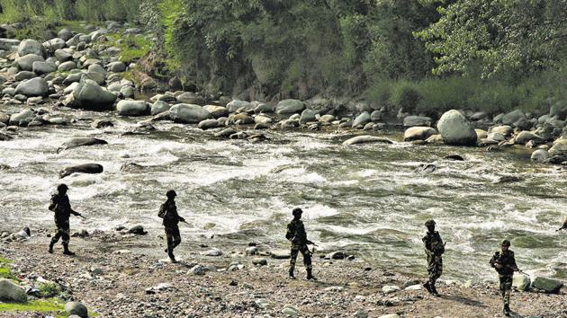 BSF soldiers patrol next to a stream near the Line of Control in Poonch district.(REUTERS)