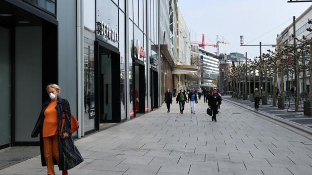 A woman wearing a protective mask is walking downtown Frankfurt, Germany. (Reuters Photo) A woman wearing a protective mask is walking downtown Frankfurt, Germany. (Reuters Photo)