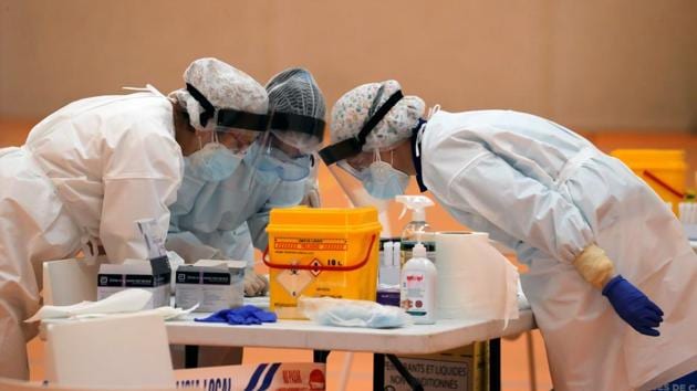 Health care workers pore over a Covid-19 rapid detection test after they collected a swab sample from a resident during mass testing in the small Andalusian village of Arriate, Spain on November 7. October has turned out to be the worst month in the pandemic’s run so far, the United States becoming the first country to report more than 100,000 daily cases and a surge in Europe adding to the rise. (Jon Nazca / REUTERS)