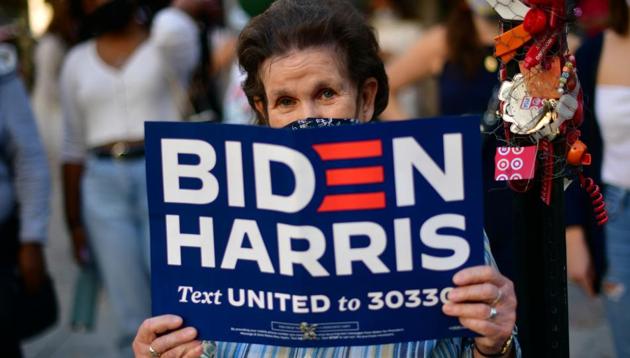 A Biden supporter holds a campaign sign, the day after a presidential election victory was called for former Vice President Joe Biden, in Philadelphia, Pennsylvania, US on November 8, 2020.(Reuters Photo) A Biden supporter holds a campaign sign, the day after a presidential election victory was called for former Vice President Joe Biden, in Philadelphia, Pennsylvania, US on November 8, 2020.(Reuters Photo)