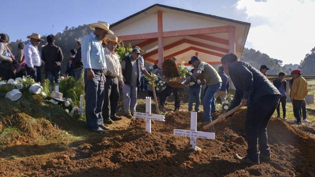 Relatives bury members of a family affected by the floods in Mukem, Mexico on November 9. Rains had threatened to overtop a dam in Tabasco over the weekend. Floods in Mexico’s Gulf coast state of Tabasco have forced about 9,000 people to evacuate and left 150,000 affected by the flooding, either because of damage to homes or crops or to displacement. (Isabel Mateos / AP)