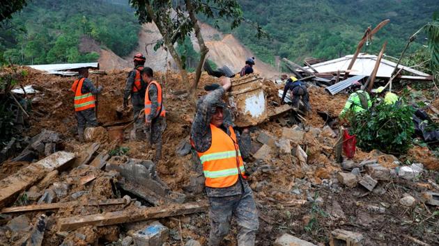 Soldiers remove debris and mud from an area hit by a mudslide caused by Storm Eta, as the search for victims continue in the buried village of Queja, Guatemala on November 7. Days after the landslide buried half the community of Queja, rescuers have recovered only a handful of the more than 100 people believed to be buried there. (Esteban Bilba / EFE / Pool via REUTERS)
