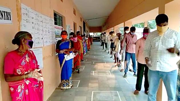 People stand in a queue as they arrive to cast their vote for state by-polls elections, in Tirtol , Odisha.(ANI)