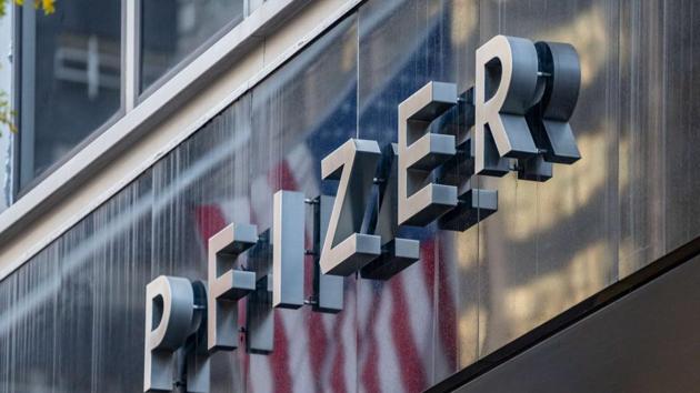 People walk by the Pfizer headquarters on November 9, 2020 in New York City. Pharmaceutical company Pfizer announced positive early results on its COVID-19 vaccine trial and has proven to be 90% effective in preventing infection of the virus. (AFP) People walk by the Pfizer headquarters on November 9, 2020 in New York City. Pharmaceutical company Pfizer announced positive early results on its COVID-19 vaccine trial and has proven to be 90% effective in preventing infection of the virus. (AFP)