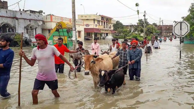 People wade through floodwater as they move to a safer place, Gopalganj, July 24, 2020 (PTI) People wade through floodwater as they move to a safer place, Gopalganj, July 24, 2020 (PTI)