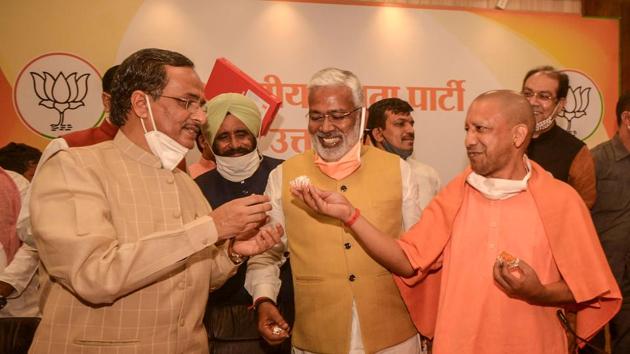 Uttar Pradesh Chief Minister Yogi Aditiyanath, Dy CM Dinesh Sharma and UP BJP President Swatantra Dev Singh celebrate the party's win bye-elections at the party office in Lucknow on Tuesday.(PTI)