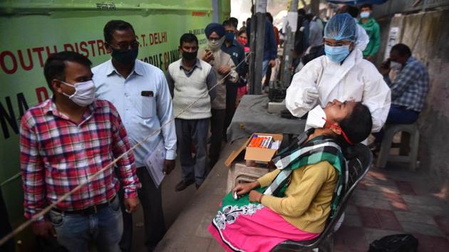 A healthcare worker in PPE coveralls collects a swab sample from a woman for coronavirus testing, in Mehrauli, New Delhi, on Tuesday.(Sanchit Khanna/HT Photo) A healthcare worker in PPE coveralls collects a swab sample from a woman for coronavirus testing, in Mehrauli, New Delhi, on Tuesday.(Sanchit Khanna/HT Photo)