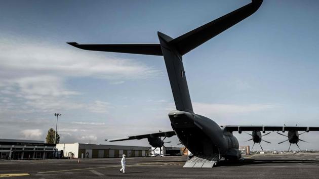 A soldier inspects a French army Airbus A400 M before transferring Covid-19 patients from Lyon-Bron airport to Paris on November 10. France is the worst-affected country in the European Union and has registered more than 48,700 infections per day over the past week. According to Reuters, 92 per cent of Paris’s ICU capacity was occupied as of November 10. (Jeff Pachoud / AFP) A soldier inspects a French army Airbus A400 M before transferring Covid-19 patients from Lyon-Bron airport to Paris on November 10. France is the worst-affected country in the European Union and has registered more than 48,700 infections per day over the past week. According to Reuters, 92 per cent of Paris’s ICU capacity was occupied as of November 10. (Jeff Pachoud / AFP)