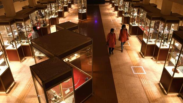 Visitors look at bronze statues displayed at the Government Museum in Chennai on November 10. The ministry in a statement said that the reopening was also in light of the festive season, so that the public can once again enjoy exploring rich cultural heritage of India. (Arun Sankar / AFP)