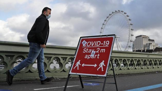 A man walks past a Covid-19 public awareness display board at Westminster Bridge in London on November 10. More than 300,000 people have died across Europe due to the viral infection and authorities fear that fatalities and infections will continue to rise as the region heads into winter, Reuters reported. (Frank Augstein / AP)