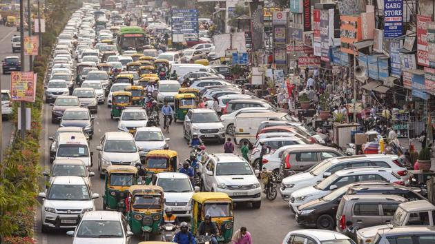 Vehicles stuck in a traffic jam as people shop for Dhanteras at Yusuf Sarai Market in New Delhi on Thursday.(PTI)