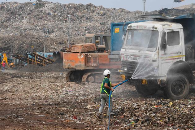 An employee of Municipal Corporation of Delhi (MCD) north-zone sprays water to control the dust at Bhalswa landfill in New Delhi. (AFP) An employee of Municipal Corporation of Delhi (MCD) north-zone sprays water to control the dust at Bhalswa landfill in New Delhi. (AFP)