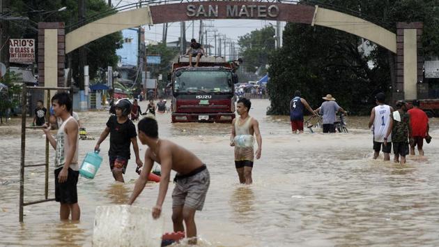 Residents negotiate a flooded road in Marikina, Philippines, on November 12. Residents posted images on social media of flooded homes and the disaster agency said parts of 36 cities and towns were inundated. (Aaron Favila / AP) Residents negotiate a flooded road in Marikina, Philippines, on November 12. Residents posted images on social media of flooded homes and the disaster agency said parts of 36 cities and towns were inundated. (Aaron Favila / AP)
