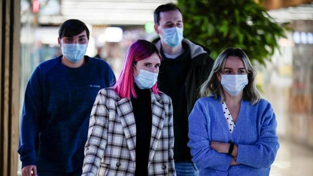 Pedestrians wear protective face masks in Moscow on November 12. (AFP) Pedestrians wear protective face masks in Moscow on November 12. (AFP)