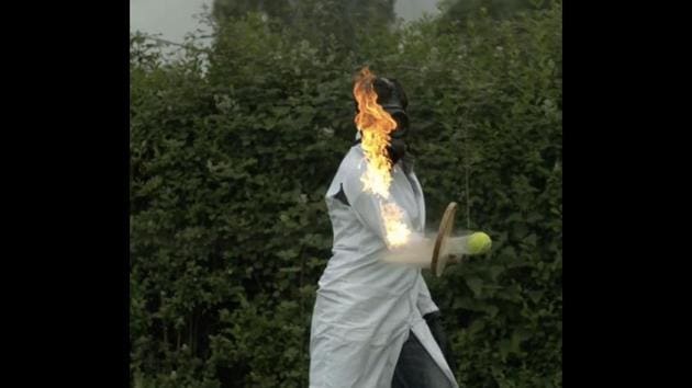 The image shows a man hitting a tennis-ball on fire with a tennis racket.(Screengrab) The image shows a man hitting a tennis-ball on fire with a tennis racket.(Screengrab)