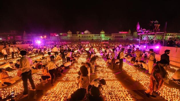 Devotees light earthen lamps on the bank of Saryu River during Deepotsav celebrations in Ayodhya in 2019. (PTI) Devotees light earthen lamps on the bank of Saryu River during Deepotsav celebrations in Ayodhya in 2019. (PTI)