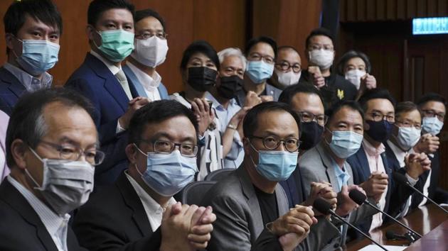 Hong Kong's pro-democracy legislators pose a picture before a press conference at the Legislative Council on November 9 ahead of their planned mass resignation.(AP) Hong Kong's pro-democracy legislators pose a picture before a press conference at the Legislative Council on November 9 ahead of their planned mass resignation.(AP)
