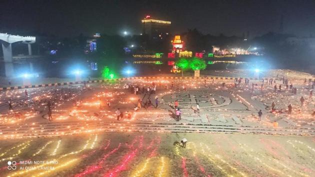 People light lamps made up of cowdung at the bank of Gomti River a day before Diwali, in Lucknow on Friday.(PTI Photo)