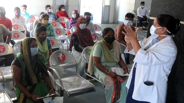 A health worker instructs people waiting to see doctors after the OPD at GMSH opened following a long gap in Sector 16, Chandigarh.(Keshav Singh/Hindustan Times) A health worker instructs people waiting to see doctors after the OPD at GMSH opened following a long gap in Sector 16, Chandigarh.(Keshav Singh/Hindustan Times)