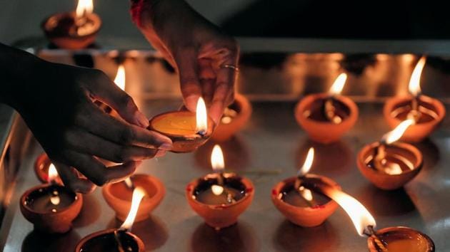 A devotee lights an oil lamp at a hindu temple to mark the Diwali festival. (Reuters photo) A devotee lights an oil lamp at a hindu temple to mark the Diwali festival. (Reuters photo)