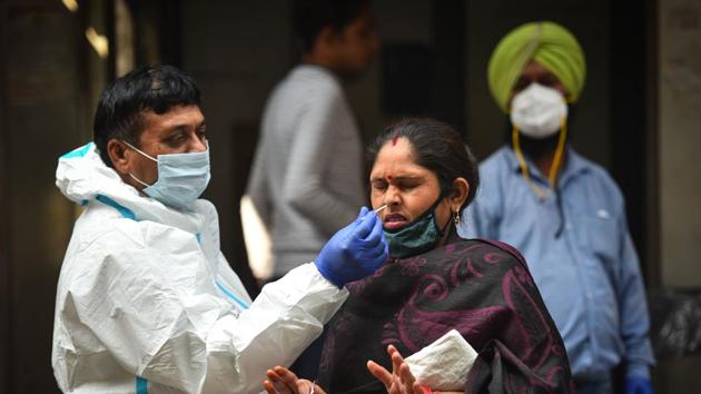 A health worker in PPE coveralls collects a swab sample from a woman for coronavirus testing, in Jahangirpuri, New Delhi.(Sanchit Khanna/HT PHOTO) A health worker in PPE coveralls collects a swab sample from a woman for coronavirus testing, in Jahangirpuri, New Delhi.(Sanchit Khanna/HT PHOTO)