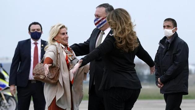 US Secretary of State Mike Pompeo, center, and his wife Susan, right, embrace U.S. Ambassador to France Jamie McCourt, left, after stepping off a plane at Paris Le Bourget Airport, Saturday, Nov. 14, 2020, in Le Bourget, France.(AP photo)