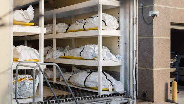 Bodies wrapped in plastic line the walls inside a refrigerated trailer used as a mobile morgue by the El Paso County Medical Examiner's office on November 13. The US added 1,431 new deaths on November 13, according to data compiled by Johns Hopkins University. The seven-day average for fatalities in America was 1,052 on November 12, close to the highest since mid-August, according to Covid Tracking Project data. (Justin Hamel / AFP)
