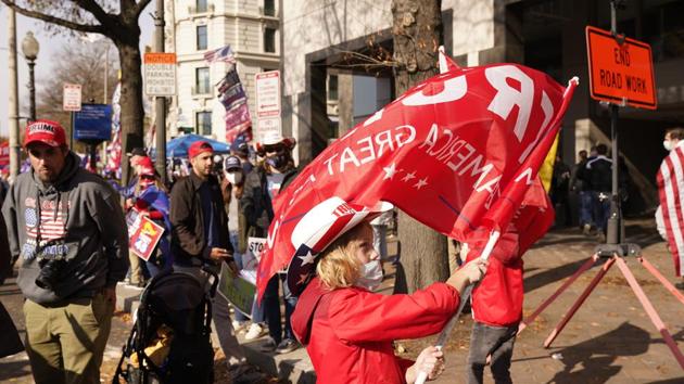 A child waves a Trump flag as supporters of President Donald Trump attend pro-Trump marches.(AP) A child waves a Trump flag as supporters of President Donald Trump attend pro-Trump marches.(AP)