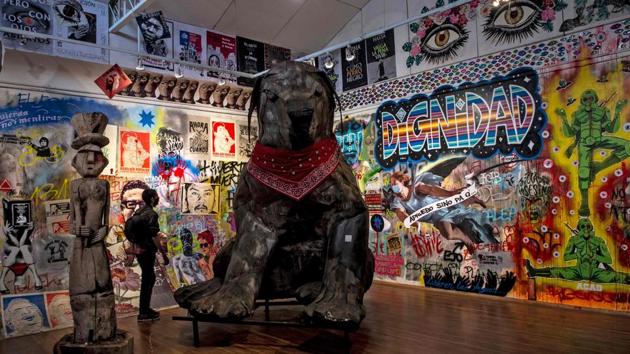 A visitor looks at a sculpture created by Marcel Sola at the Social Uprising Museum in Santiago on November 11. This giant sculpture of a stray dog with a red bandana around its neck is the largest piece in the museum. It became a symbol of the uprising and the black dog attained celebrity status after protesters nicknamed the animal “Negro Matapacos” -- or Black Cop-Killer, AFP reported. (Martin Barnetti / AFP)
