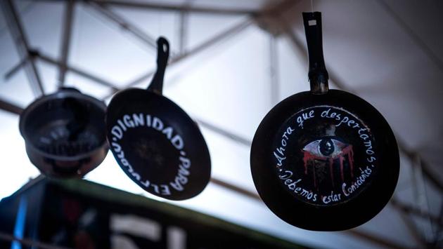 Pots and pans used during the demonstrations displayed at the Social Uprising Museum in Santiago on November 11. These pots and pans were frantically beaten by ordinary men and women, to make their anger heard in countless “cacerolazo” protests. The ones that hang in the museum bear the words: “Now that we woke up, we must be conscious,” AFP reported. (Martin Barnetti / AFP)