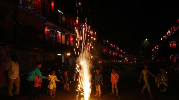 Children celebrate Diwali with crackers at housing society near Dandekar bridge on Saturday in Pune, India.(Photo by Rahul Raut/HT PHOTO) Children celebrate Diwali with crackers at housing society near Dandekar bridge on Saturday in Pune, India.(Photo by Rahul Raut/HT PHOTO)