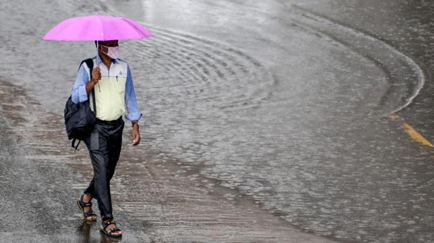 A man carrying an umbrella walks on the roadside under heavy rains in Chennai on November 12. Health minister Harsh Vardhan had said on November 13 that India has initiated an integrated response to overcome the unprecedented Covid-19 pandemic. (Arun Sankar / AFP) A man carrying an umbrella walks on the roadside under heavy rains in Chennai on November 12. Health minister Harsh Vardhan had said on November 13 that India has initiated an integrated response to overcome the unprecedented Covid-19 pandemic. (Arun Sankar / AFP)