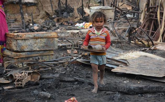 A child collecting whatever is left of his home following the fire at Saketri village in Panchkula on Sunday. (Sant Arora /HT) A child collecting whatever is left of his home following the fire at Saketri village in Panchkula on Sunday. (Sant Arora /HT)