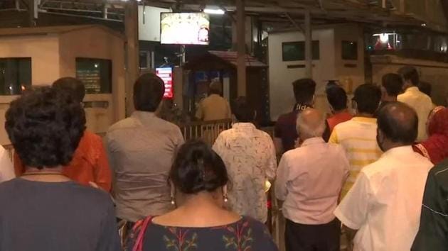 Devotees gather outside the Siddhivinayak temple in Mumbai early on Monday.(ANIPphoto)