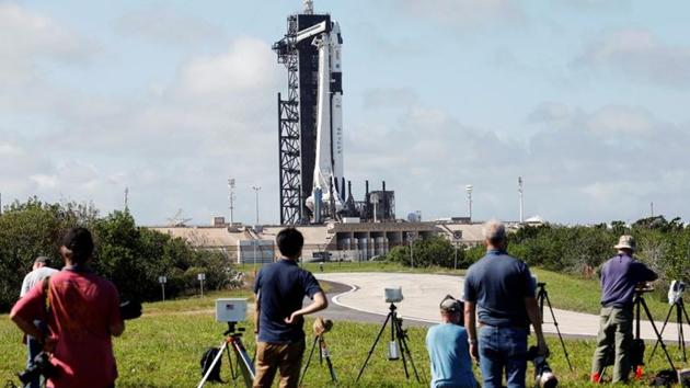 Photographers set up remote cameras before the launch of NASA’s first operational commercial crew mission at Kennedy Space Center in Cape Canaveral, Florida on November 13. According to NASA officials, an air leak caused an unexpected drop in capsule pressure less than two hours before launch, Reuters reported. (Thom Baur / REUTERS)