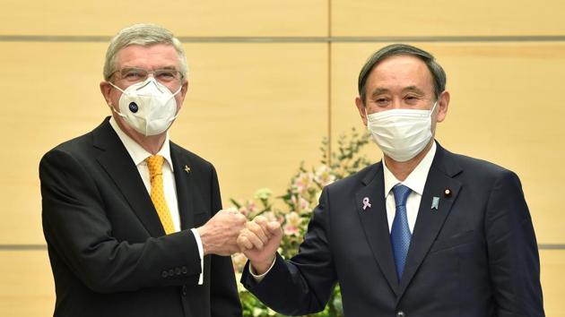 Japan's Prime Minister Yoshihide Suga (R) greets International Olympic Committee (IOC) president Thomas Bach during their meeting in Tokyo on November 16, 2020. Kazuhiro Nogi/Pool via REUTERS TPX IMAGES OF THE DAY(REUTERS)