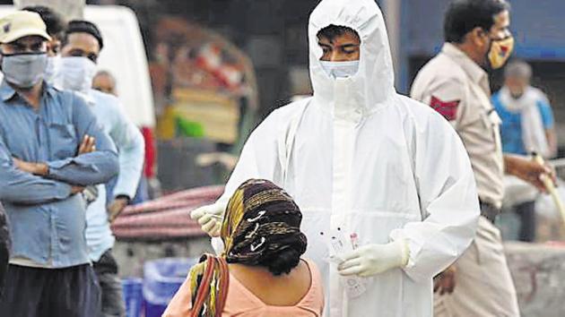 A health worker collects a swab sample for a coronavirus test . The positivity rate in the state now stands at 5.80%.(HT PHOTO.) A health worker collects a swab sample for a coronavirus test . The positivity rate in the state now stands at 5.80%.(HT PHOTO.)