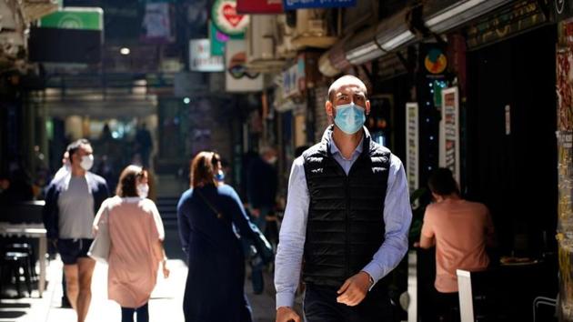 People walk down a city laneway in the state of Victoria, in Melbourne, Australia. Overall,  the country has been relatively successful in containing the virus, with just over 27,700 cases and 907 deaths recorded since the pandemic began. (Reuters)