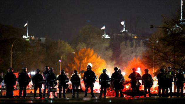 Police officers stand in line as they monitor a protest following the “Million MAGA March” from Freedom Plaza to the Supreme Court, on November 14. As night fell, multiple police lines kept the two sides apart. (Tasos Katopodis / Getty Images / AFP) Police officers stand in line as they monitor a protest following the “Million MAGA March” from Freedom Plaza to the Supreme Court, on November 14. As night fell, multiple police lines kept the two sides apart. (Tasos Katopodis / Getty Images / AFP)
