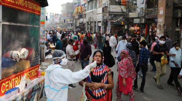 A healthcare worker collects a swab sample from a woman amidst the spread of the coronavirus disease (COVID-19), at a market, in the old quarters of Delhi.(Reuters) A healthcare worker collects a swab sample from a woman amidst the spread of the coronavirus disease (COVID-19), at a market, in the old quarters of Delhi.(Reuters)